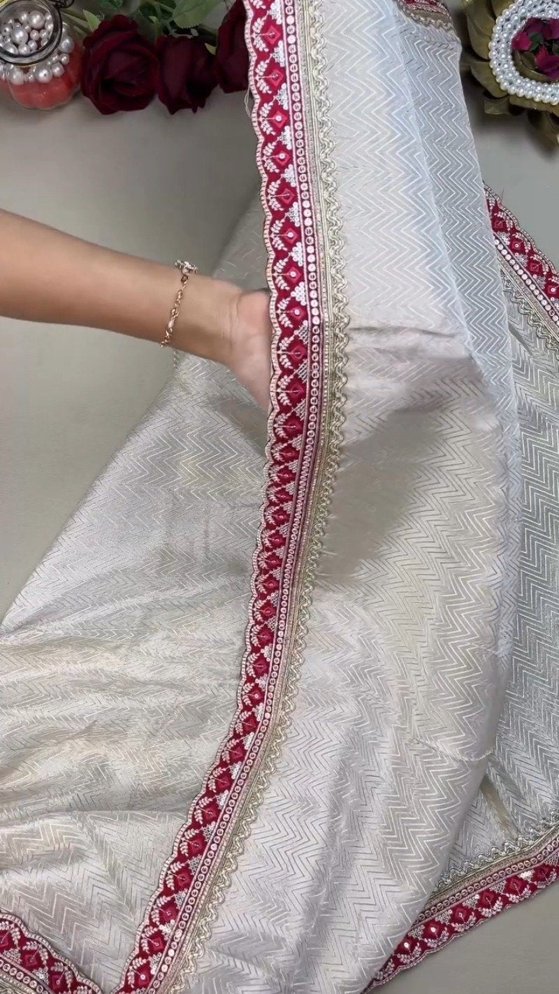 Ivory Chevron Pattern Saree with Embellished Deep Magenta Blouse – Elegant Festive Drape